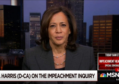 Sen. Kamala Harris sitting in front of background image of Atlanta skyline