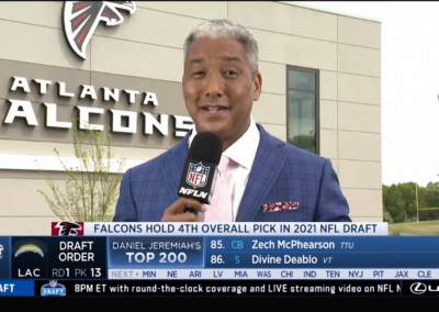 reporter Steve Wyche standing in front of atlanta falcons building